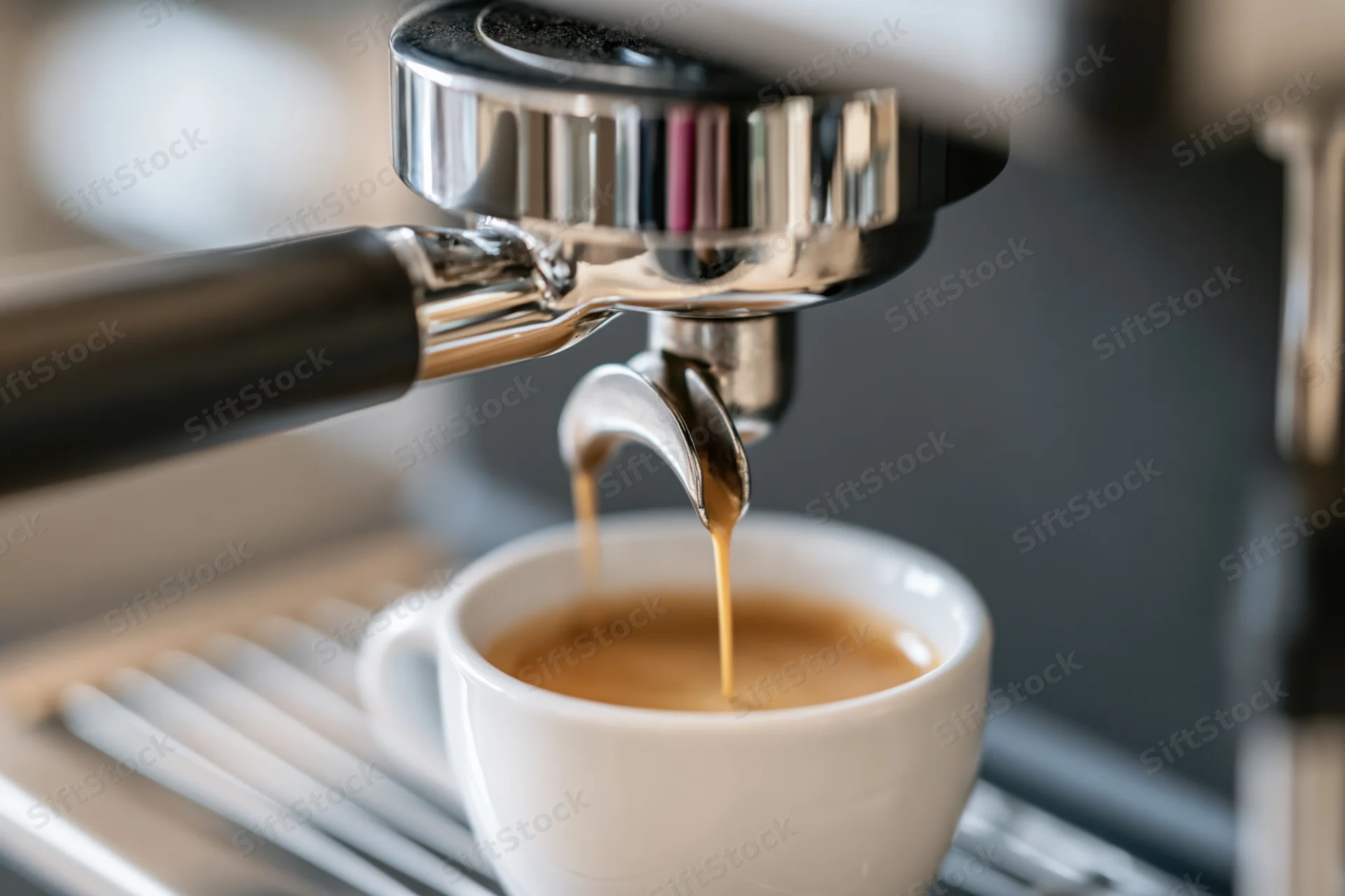 Espresso machine dispensing coffee into a white cup on a metal tray