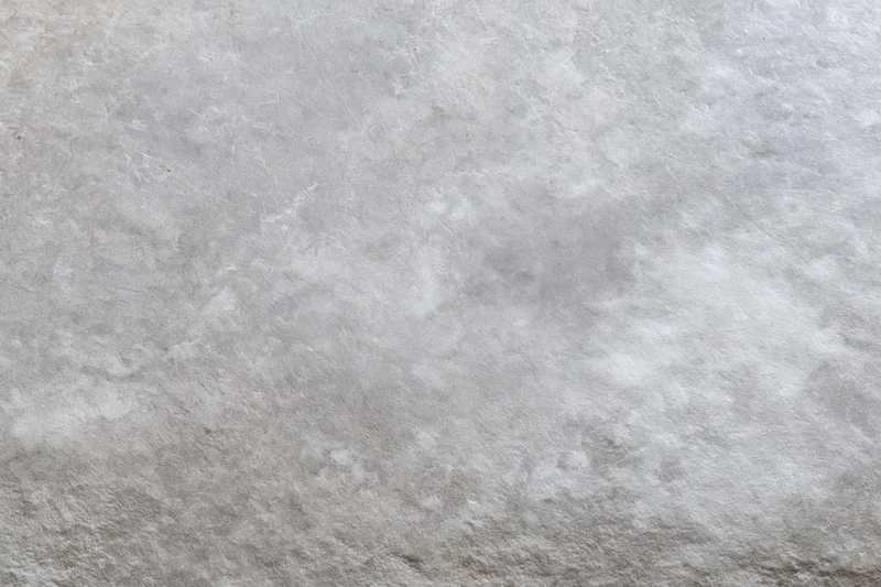 Flat gray concrete surface filling the frame with rough texture