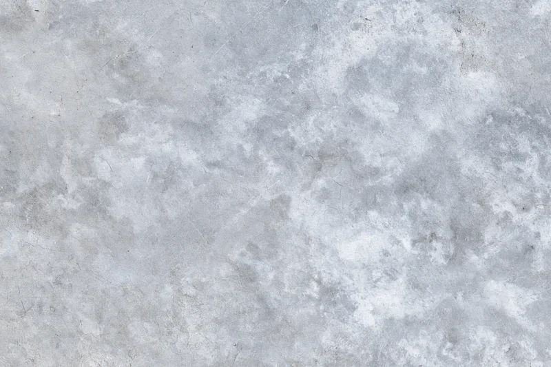 Flat gray concrete surface filling the frame with rough texture and subtle imperfections
