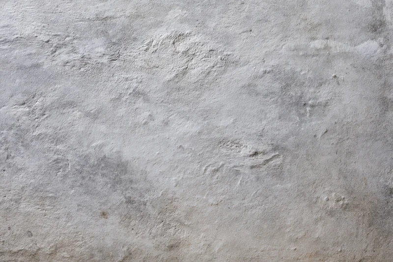 Close-up of a rough gray concrete wall surface filling the frame
