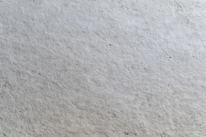 Flat bare concrete wall surface filling the entire frame