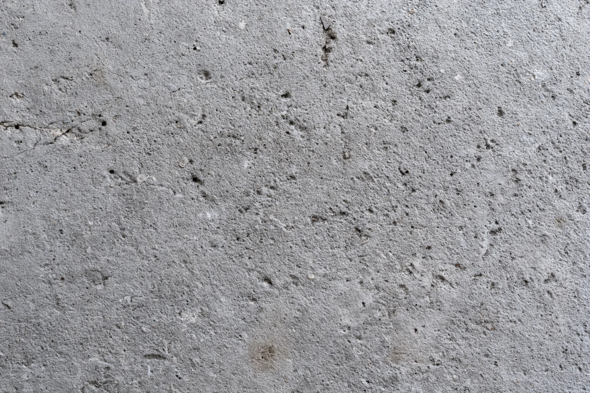 Close-up of a rough gray concrete wall surface filling the frame