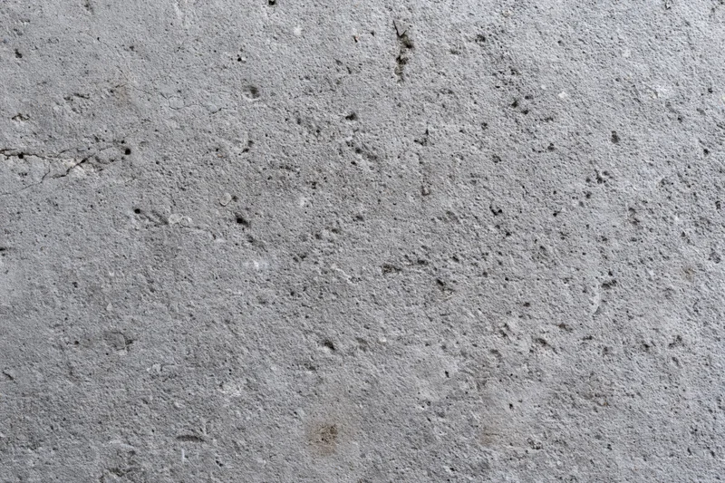 Close-up of a rough gray concrete wall surface filling the frame