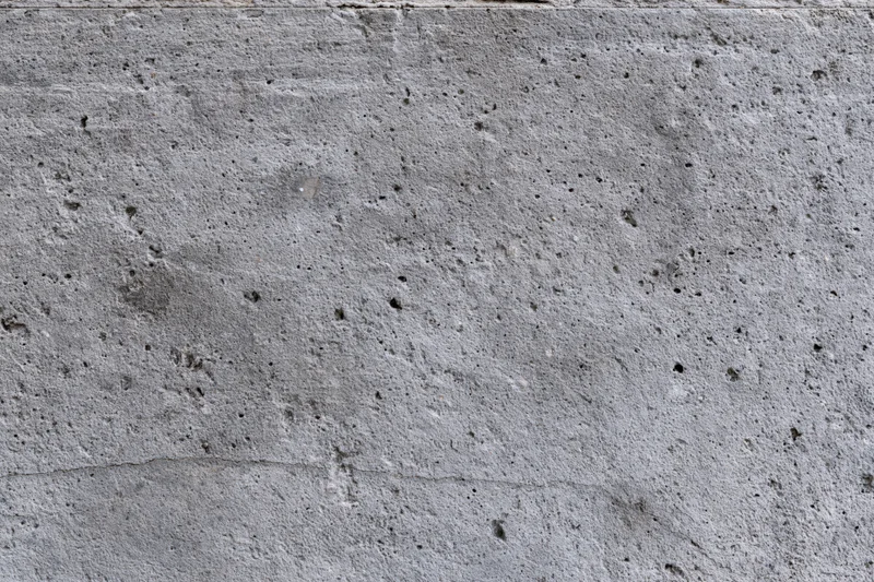 Close-up of a rough gray concrete wall surface filling the frame