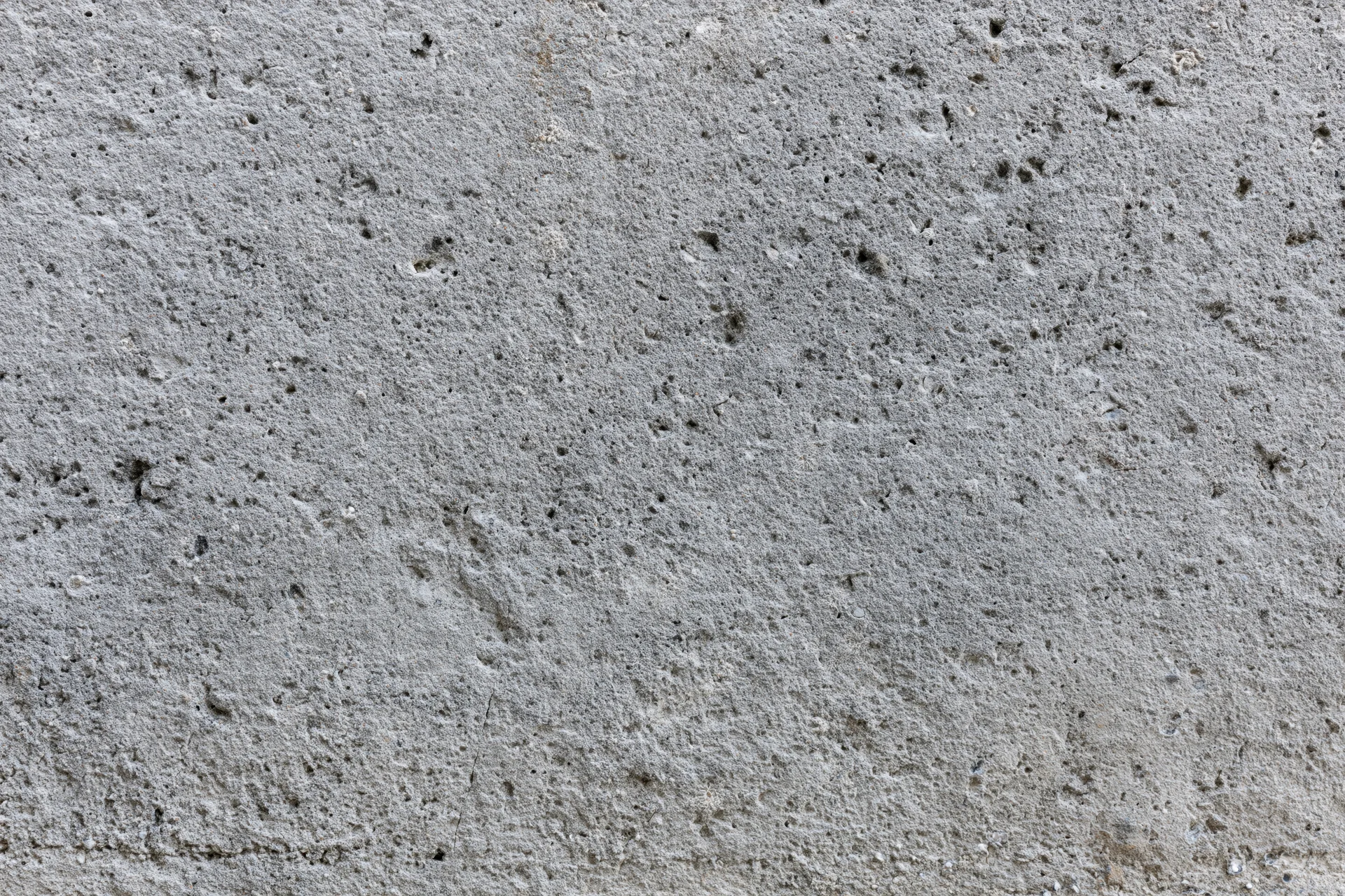 Close-up of a rough gray concrete wall surface filling the frame