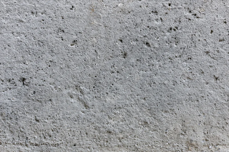 Close-up of a rough gray concrete wall surface filling the frame