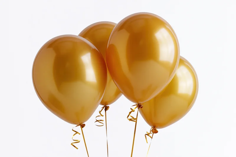 Four glossy gold helium balloons clustered together on white background
