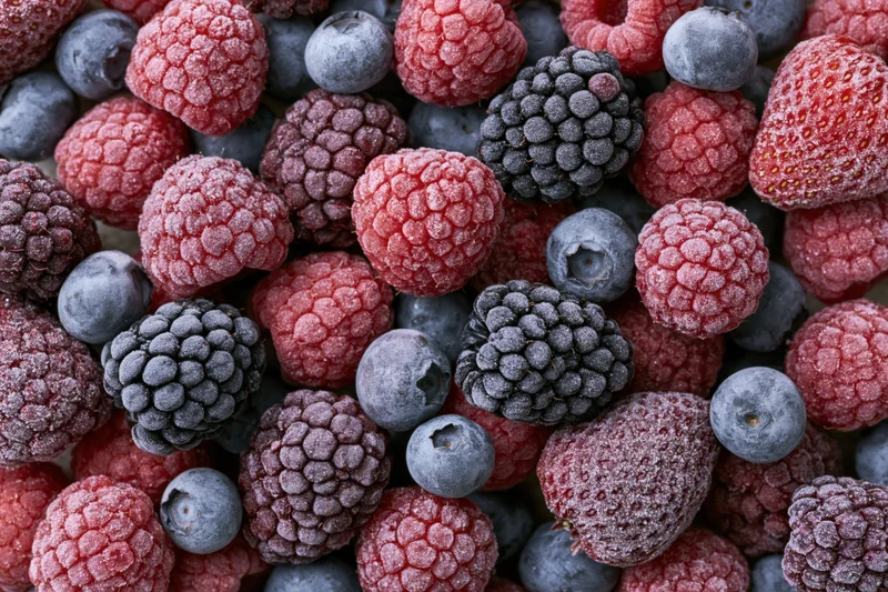 Frozen mixed berries densely packed in a close-up view