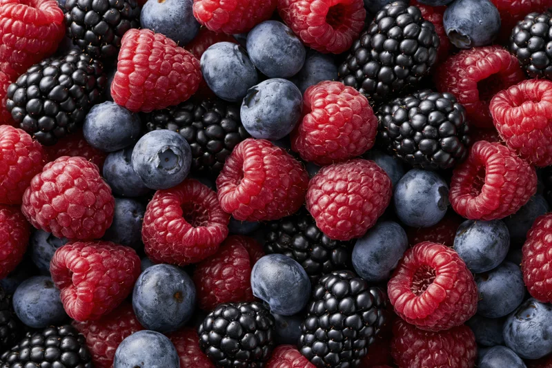 Overhead flat-lay of mixed fresh berries raspberries blueberries
