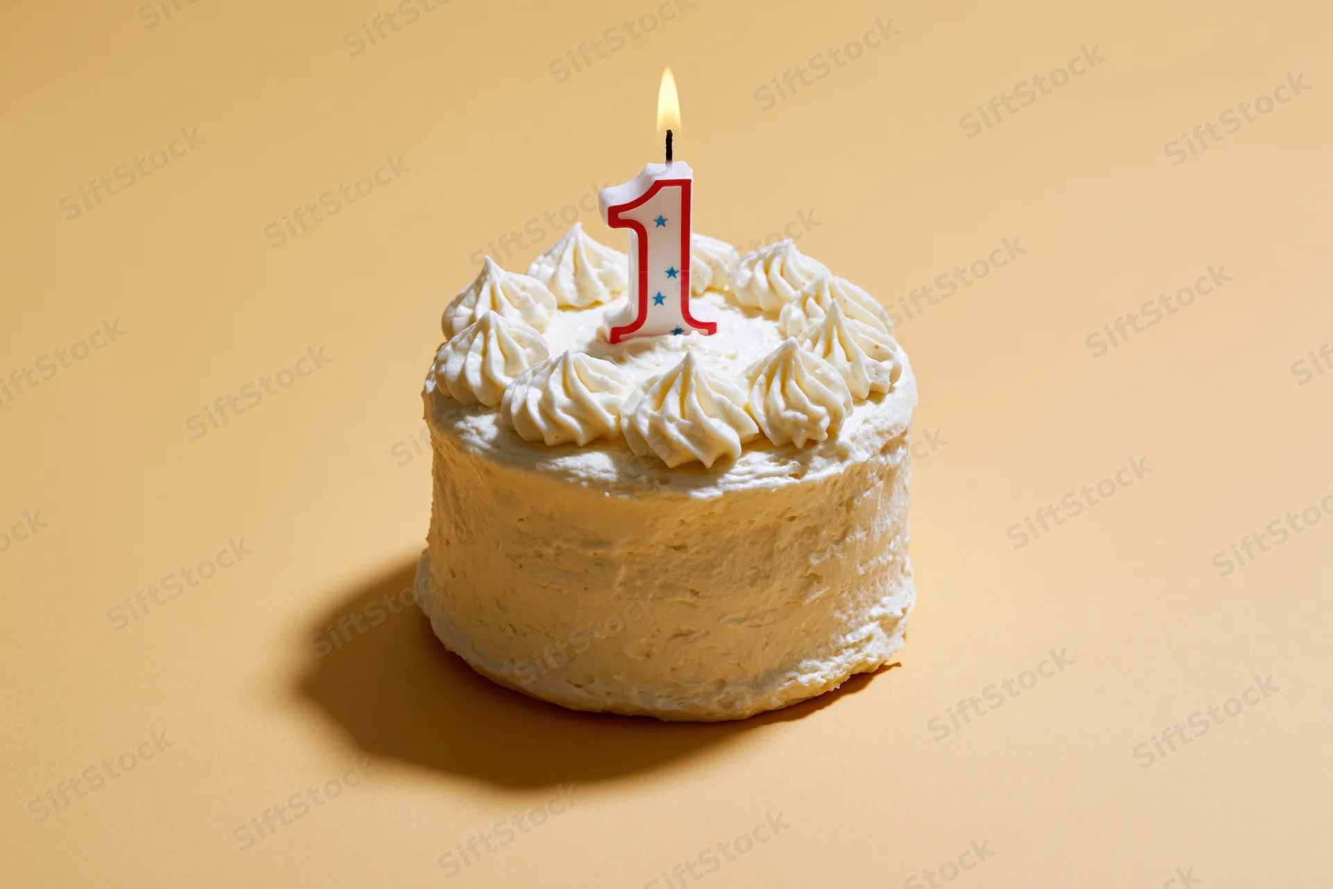Small white frosted cake with lit number one candle on beige background
