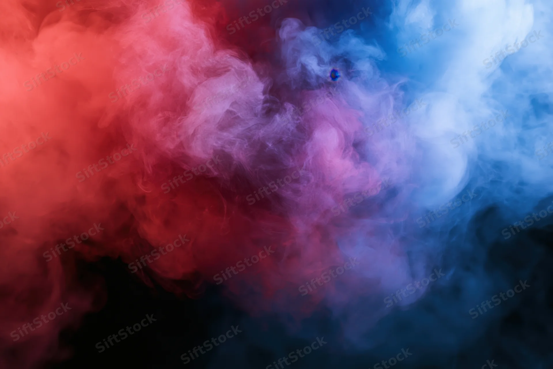 Swirling red and blue smoke filling the frame against a black background