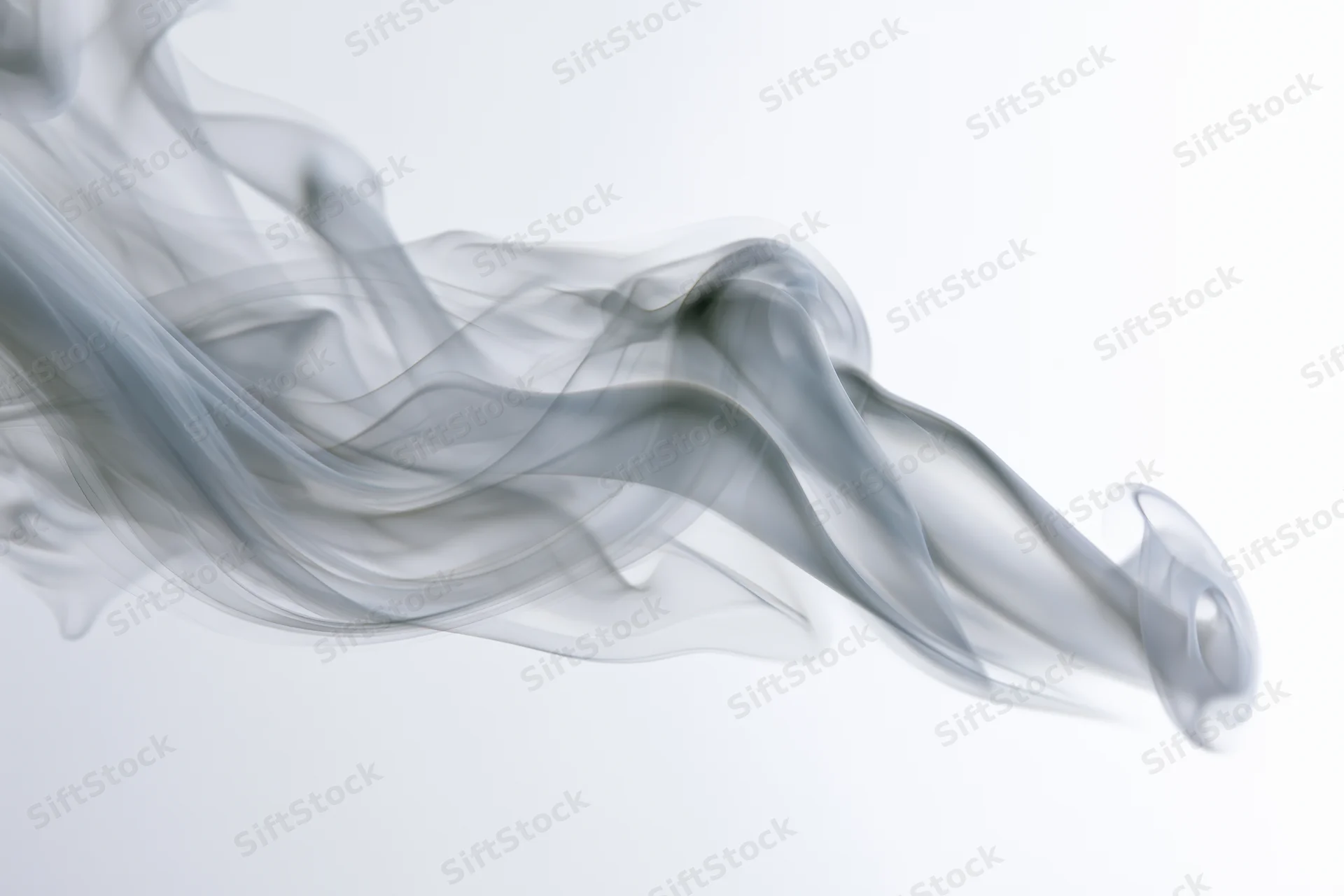 Gray smoke swirling and curling against a white background