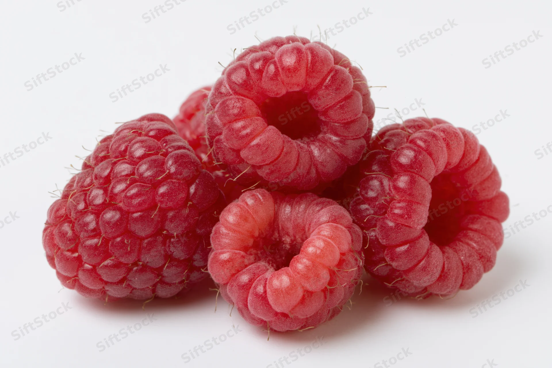 Cluster of fresh raspberries on white background