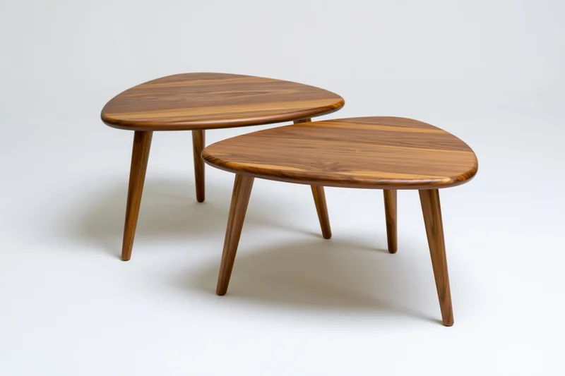 Two midcentury modern wooden nesting coffee tables on white background