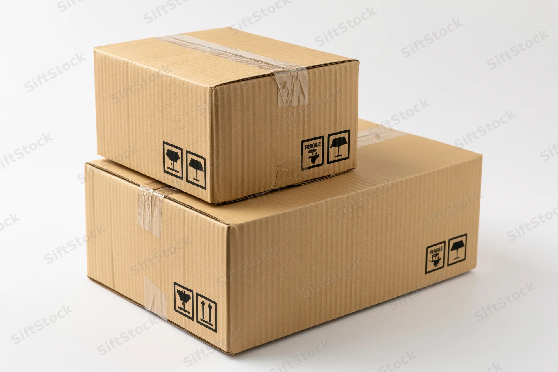 Two sealed corrugated cardboard shipping boxes stacked on a white surface