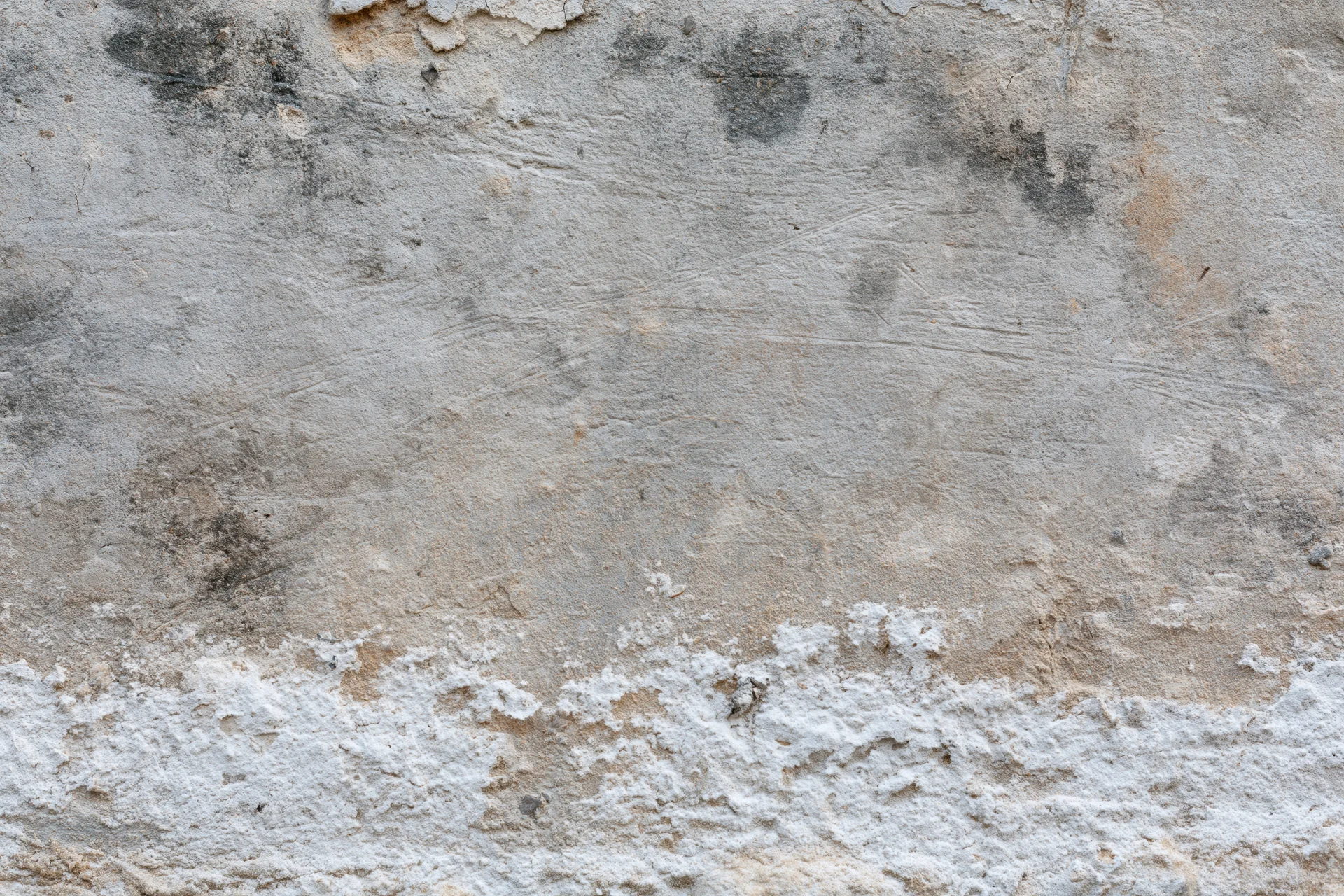 Weathered concrete wall surface filling the frame with peeling and cracked texture
