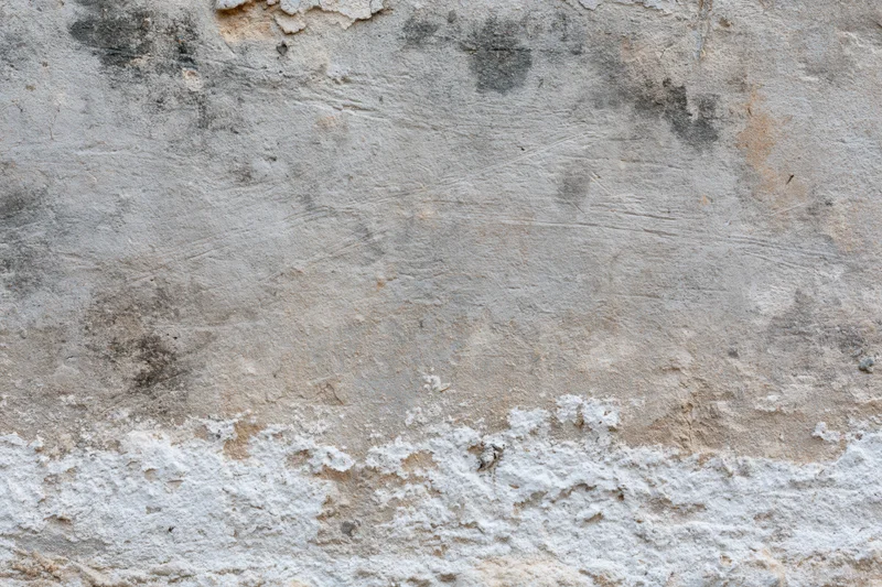 Weathered concrete wall surface filling the frame with peeling and cracked texture