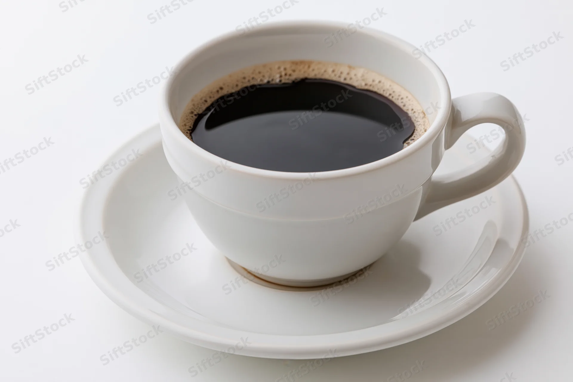 White ceramic coffee cup filled with black coffee on a matching saucer against a plain white background