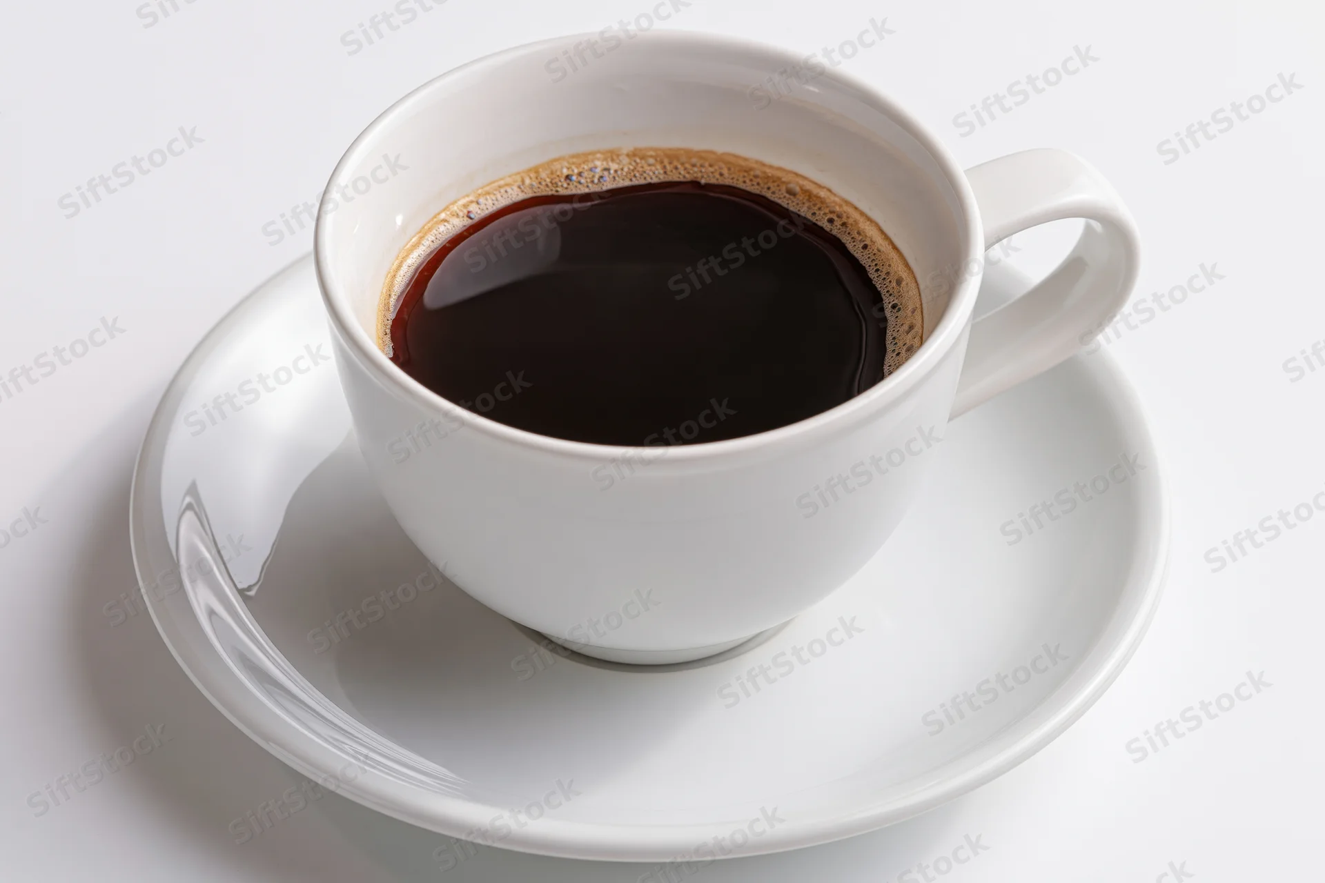 White ceramic coffee cup filled with black coffee on a matching saucer against a plain white background