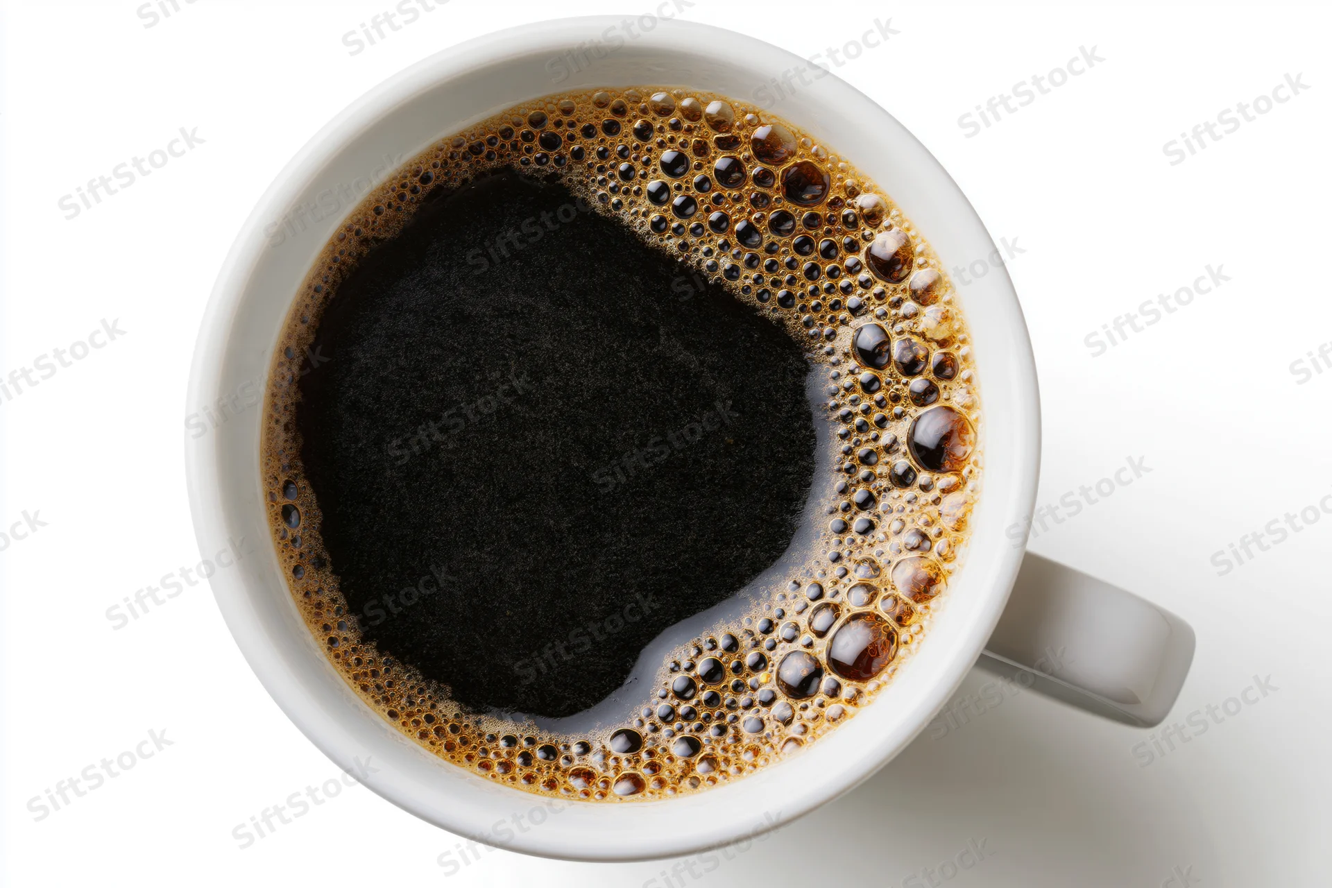 Overhead view of a white ceramic mug filled with black coffee and foam on a plain white surface