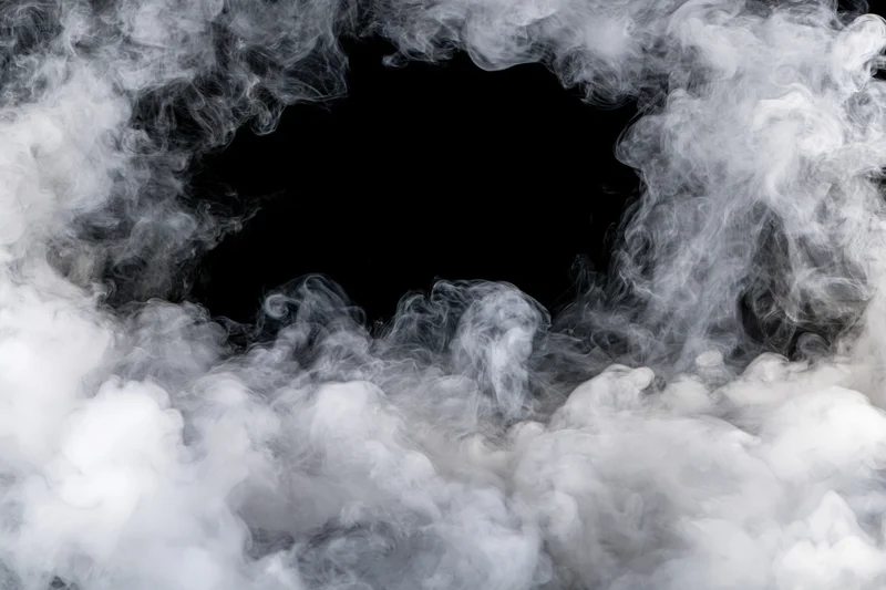White smoke swirling around a black circular opening in the center