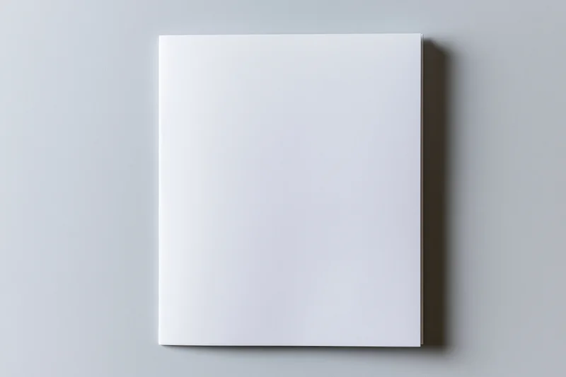 Blank white brochure lying flat on a gray surface