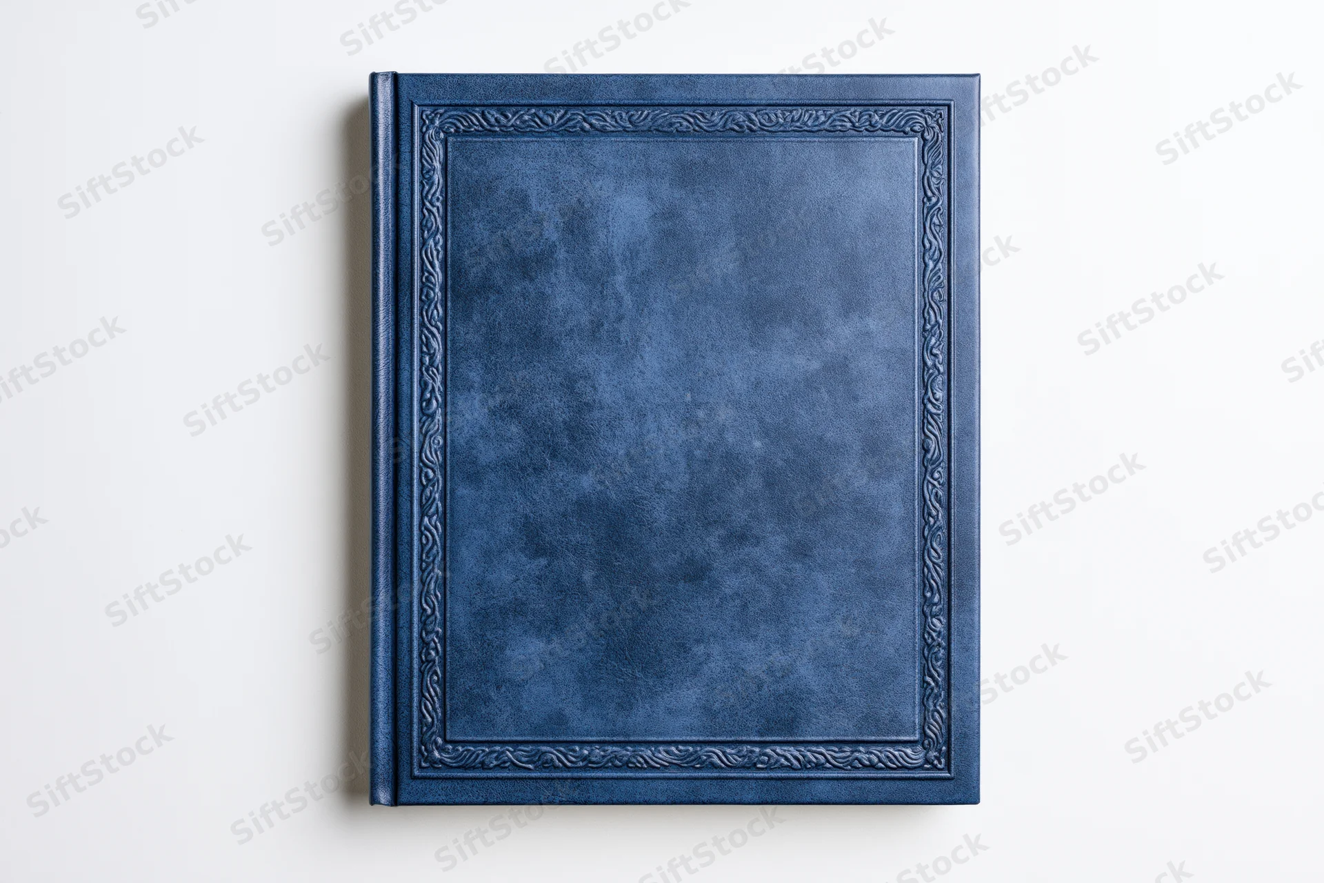 Navy blue leather-bound hardcover book with embossed frame on white background