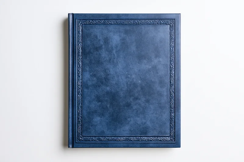 Navy blue leather-bound hardcover book with embossed frame on white background