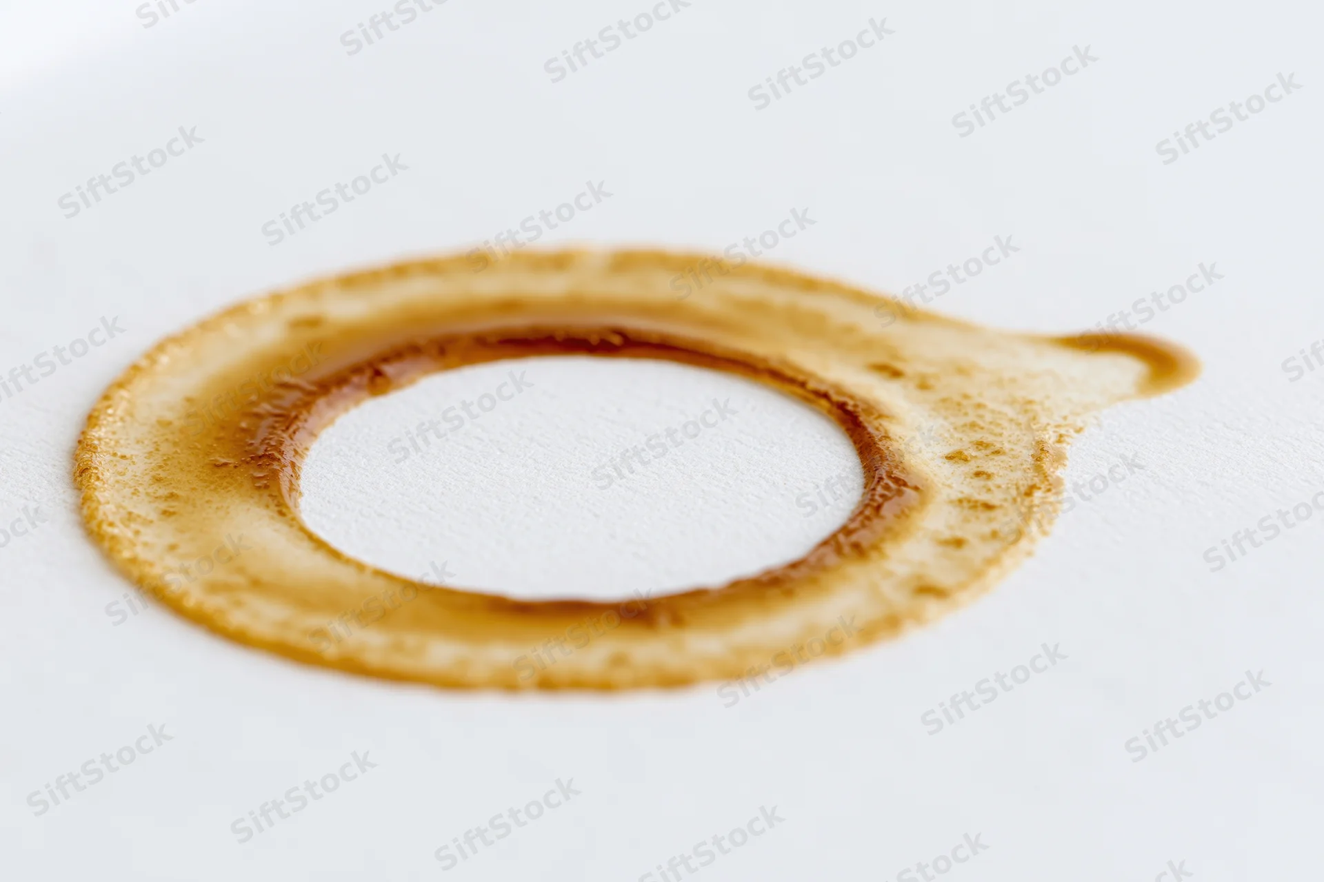 Dried coffee ring stain on a white surface