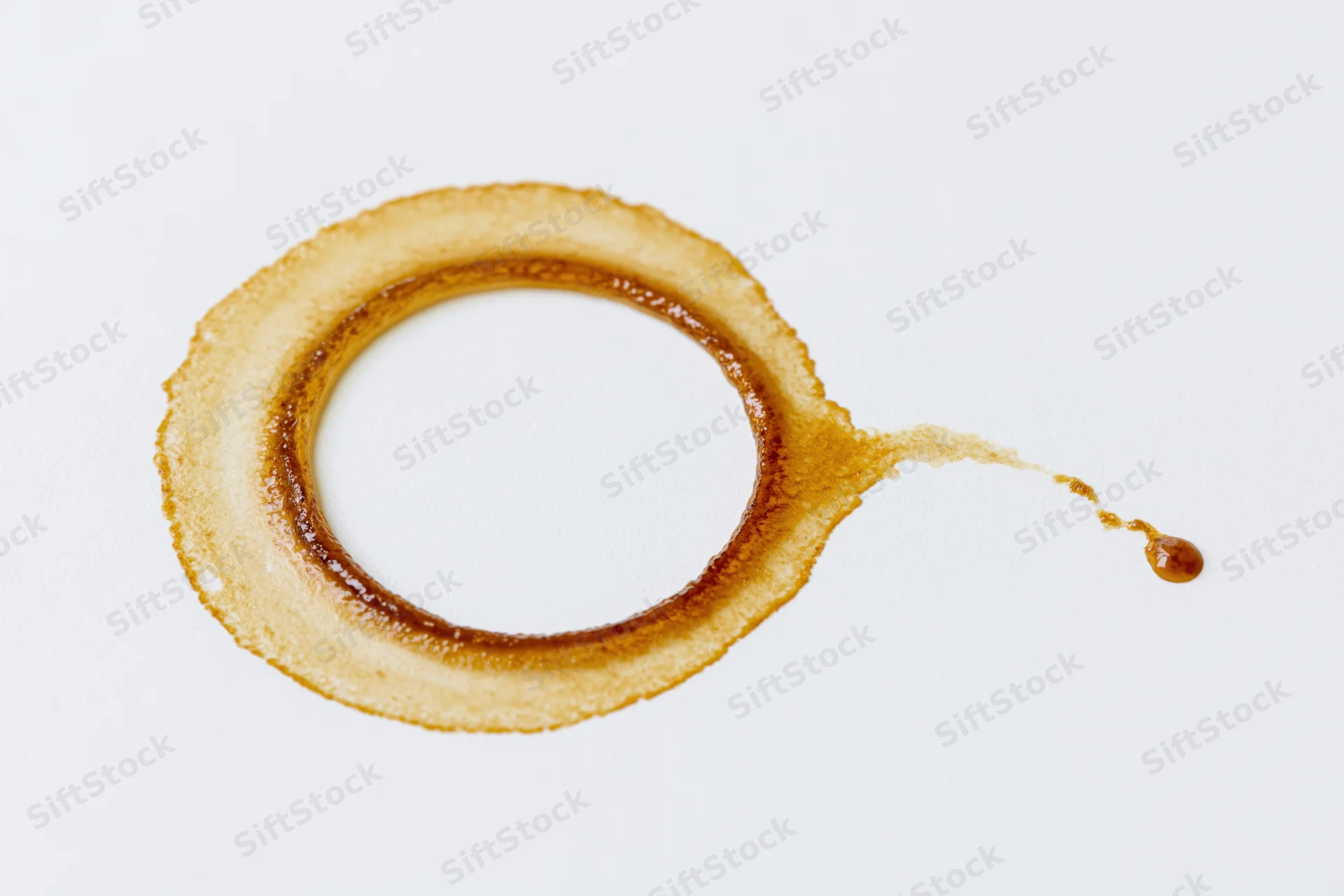 Dried coffee ring stain on a white surface