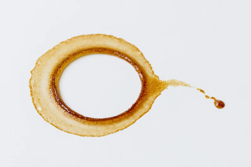 Dried coffee ring stain on a white surface