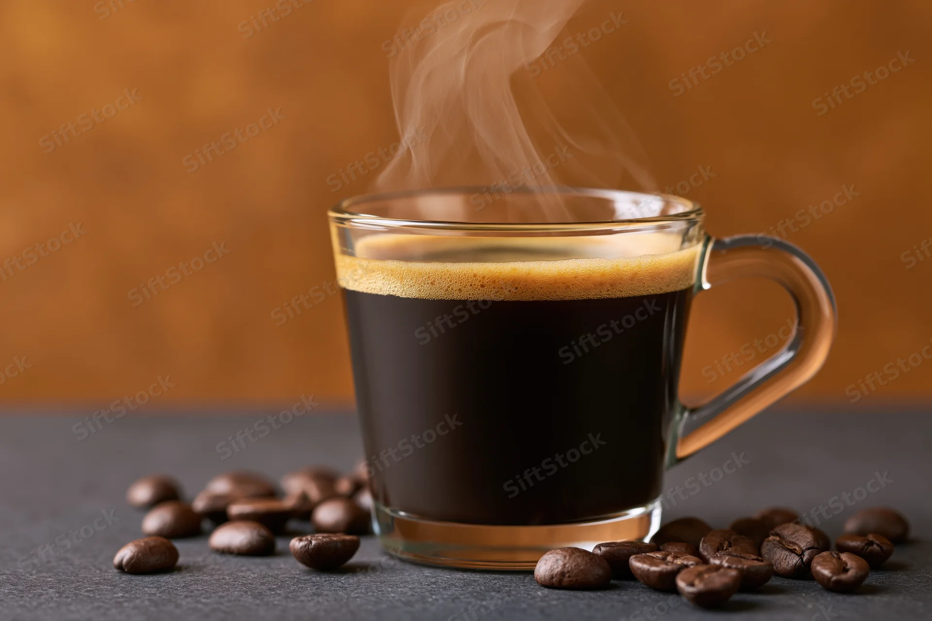 Steaming black coffee in a glass cup surrounded by roasted beans on a dark surface