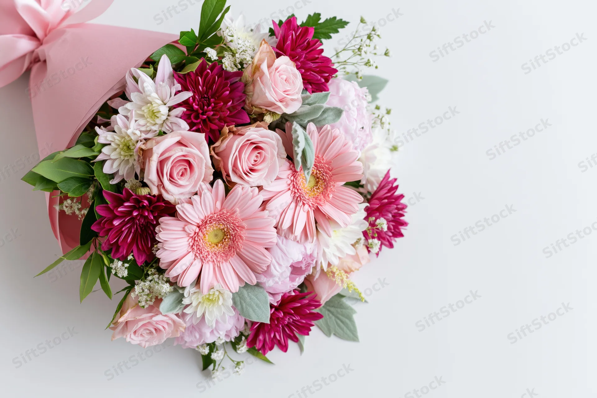 Mixed floral bouquet with pink roses, gerbera daisies and greenery on white background