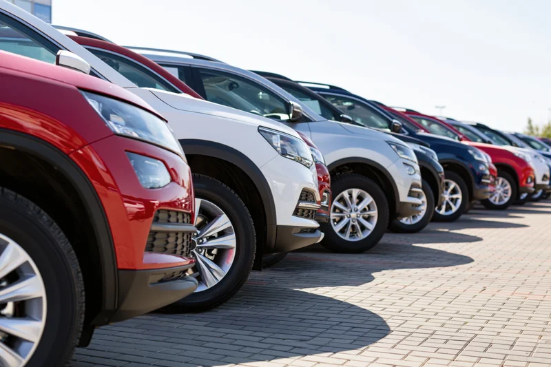 Row of suvs parked diagonally on paved dealership lot