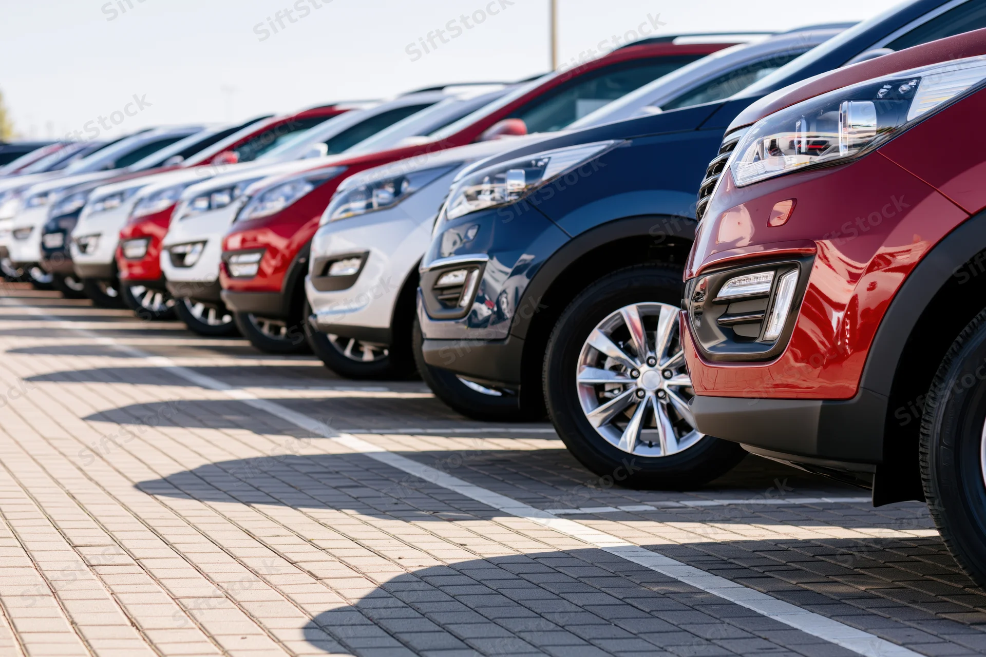 Row of suvs parked diagonally on paved dealership lot
