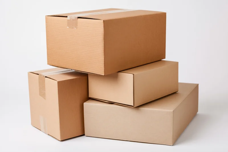 Stack of three cardboard shipping boxes arranged in a pyramid on a white background