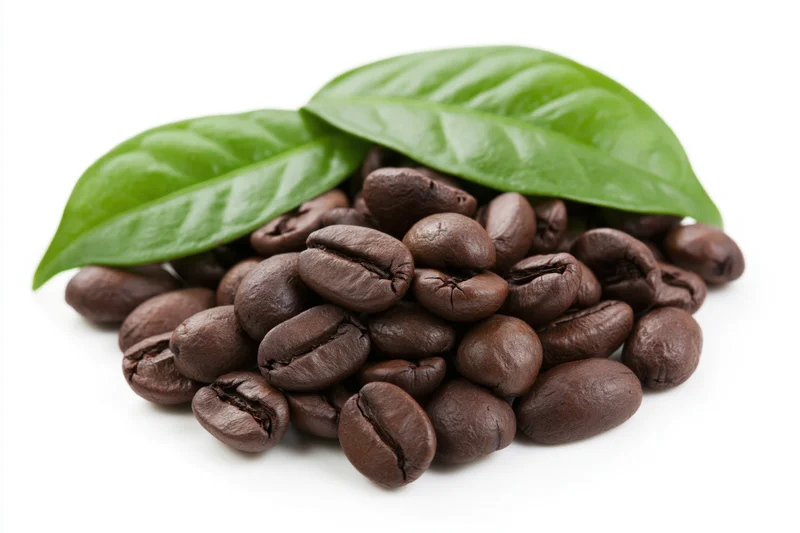 Roasted coffee beans with green leaves on white background