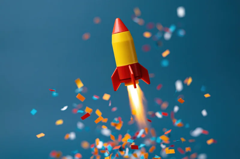Toy rocket launching upward with flame and confetti against blue background