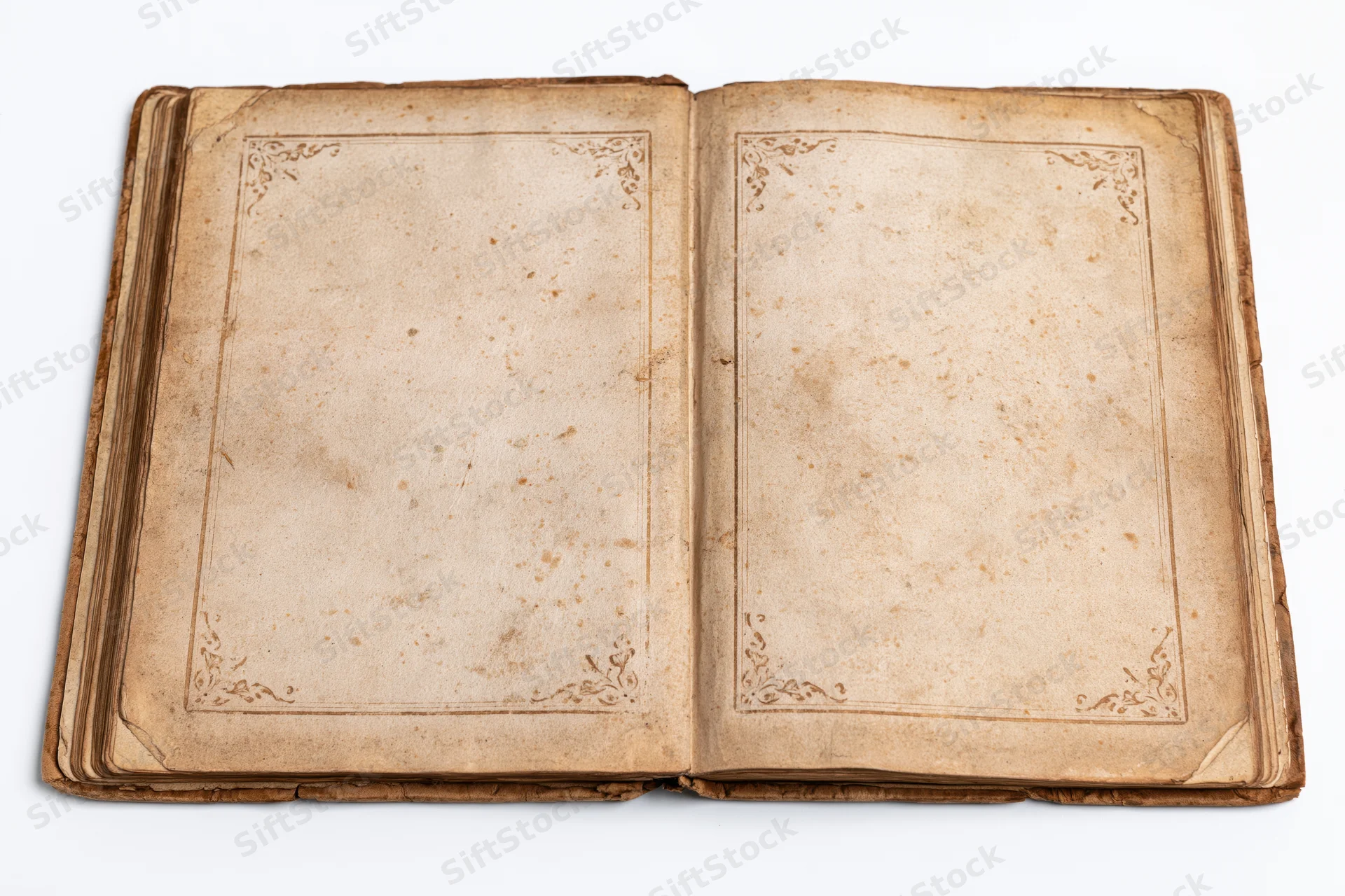 Open antique book with blank aged pages and ornate borders on white background
