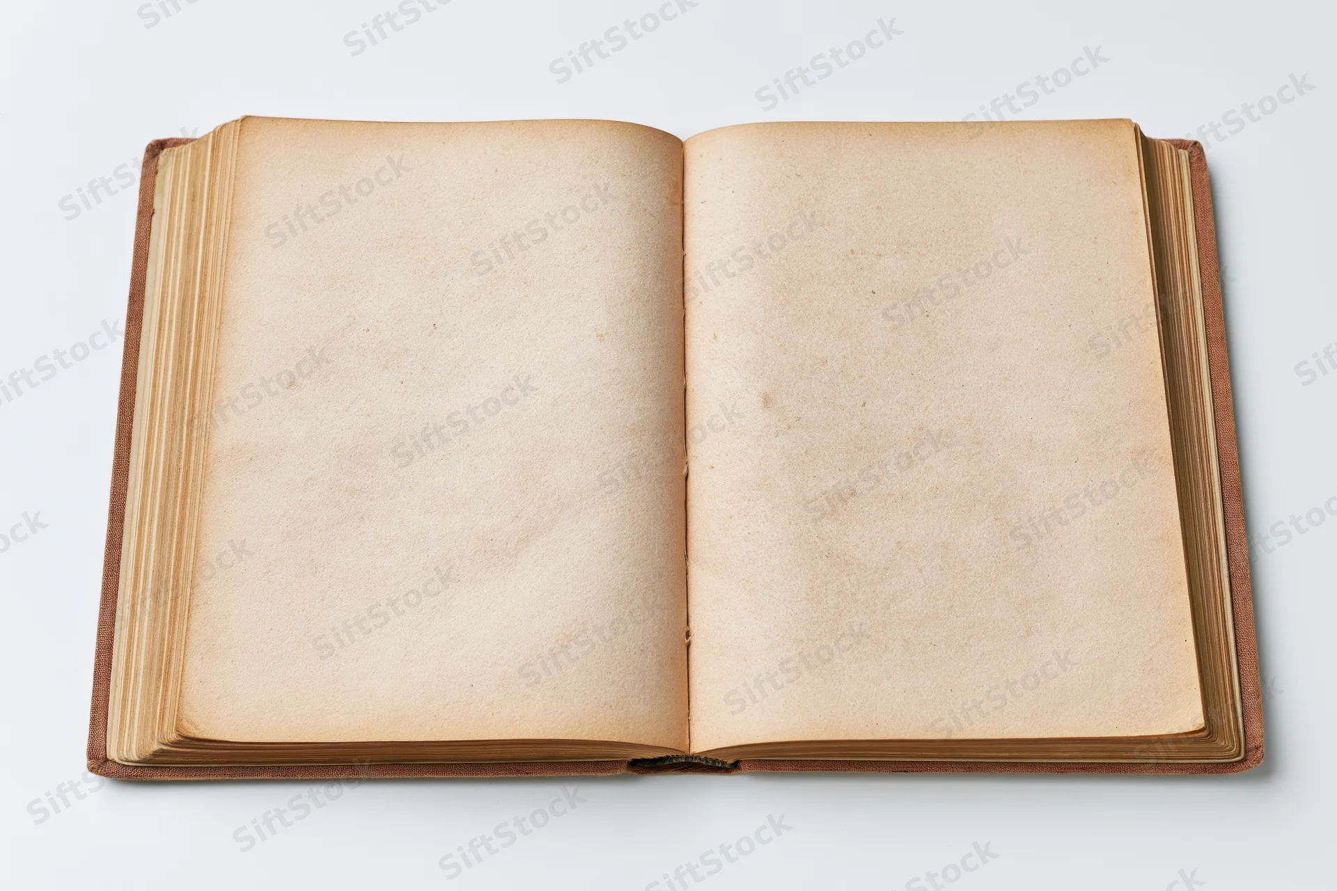 Open vintage hardcover book with blank yellowed pages on white background