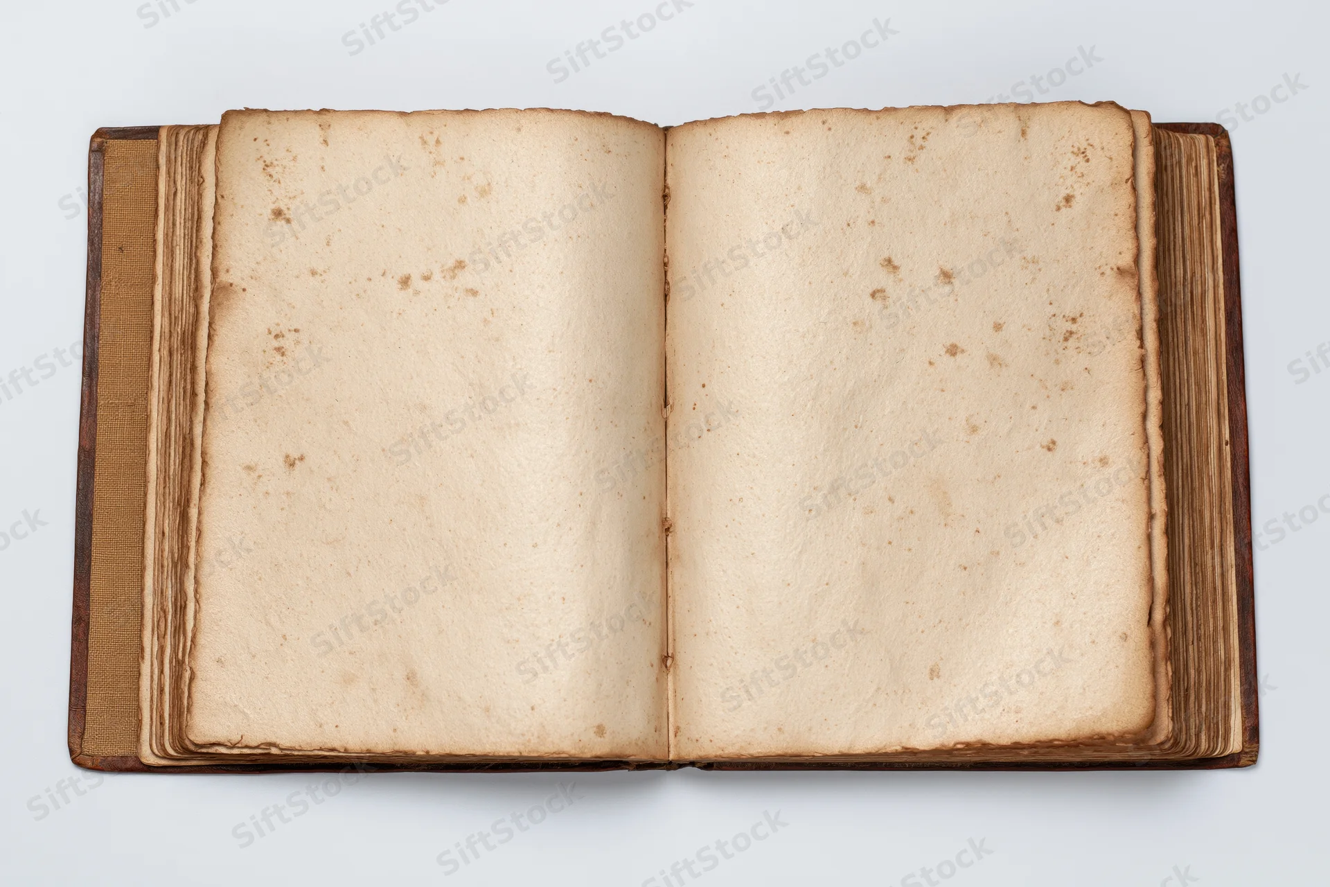 Open vintage book with blank yellowed pages on white background