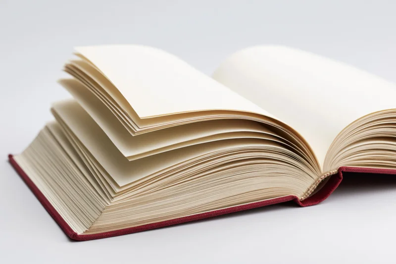 Open hardcover book with pages fanned wide on white background
