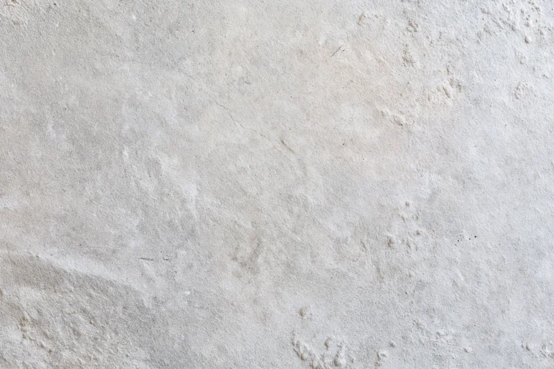 Close-up of a bare concrete wall surface with rough texture and subtle imperfections