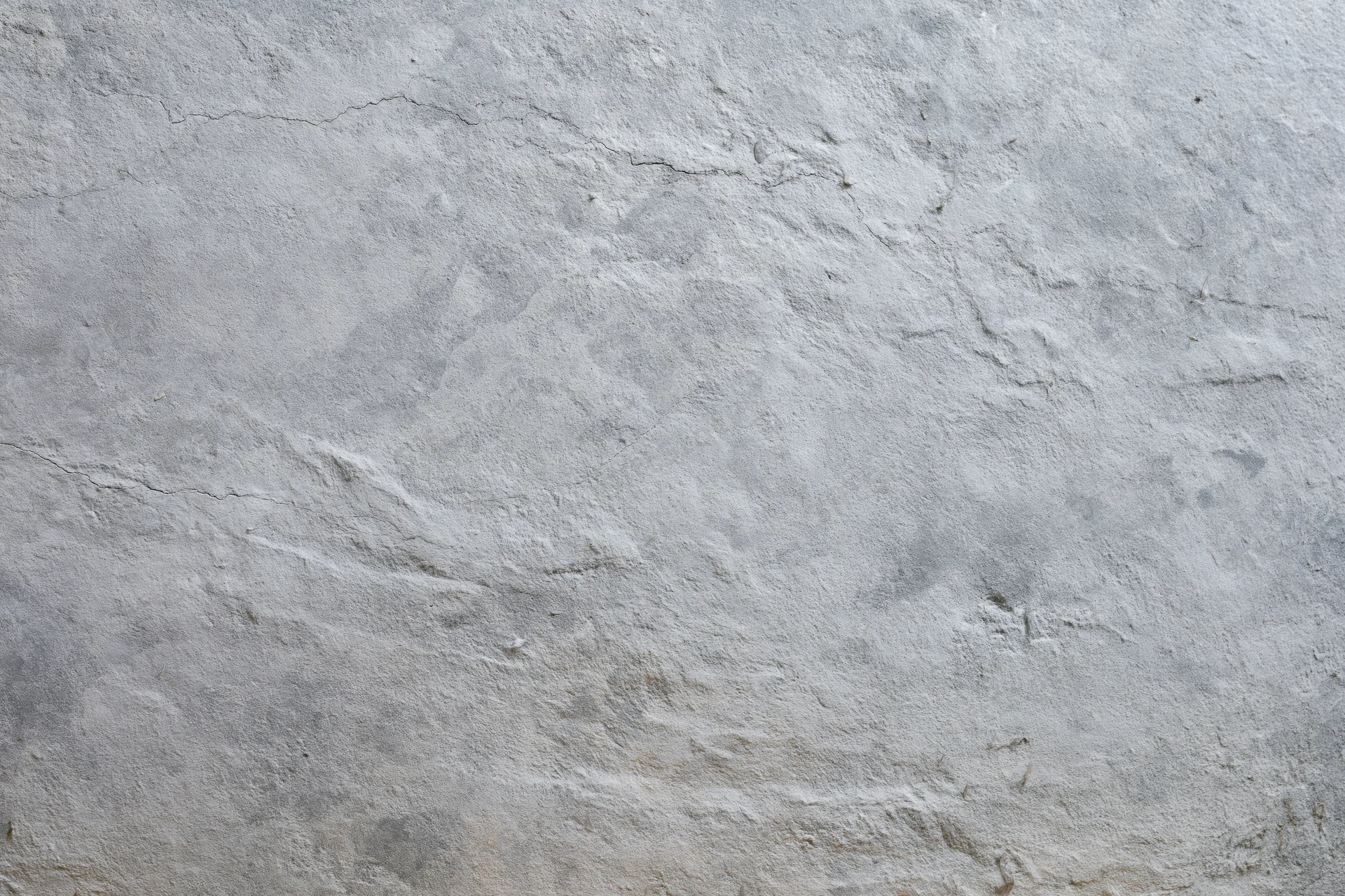 Close-up of a rough gray concrete wall surface filling the frame