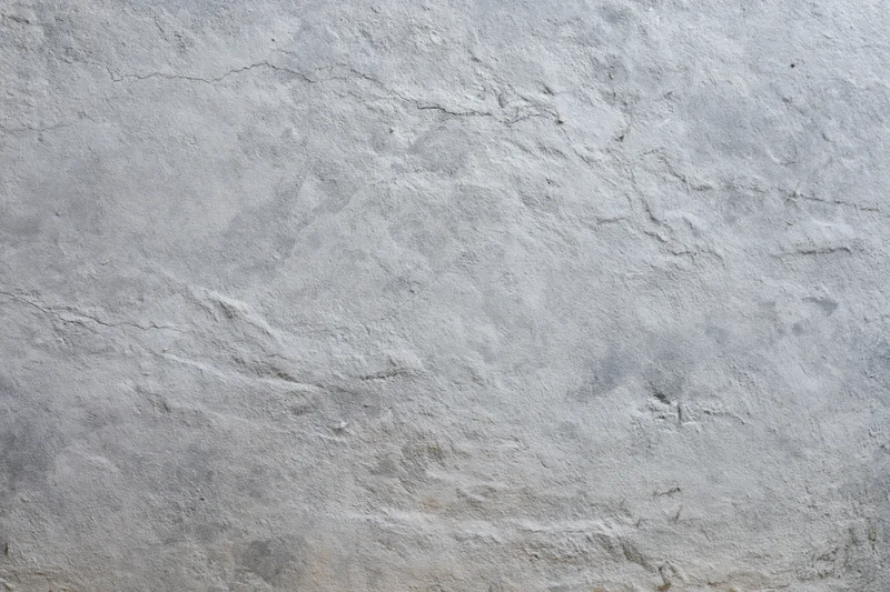 Close-up of a rough gray concrete wall surface filling the frame