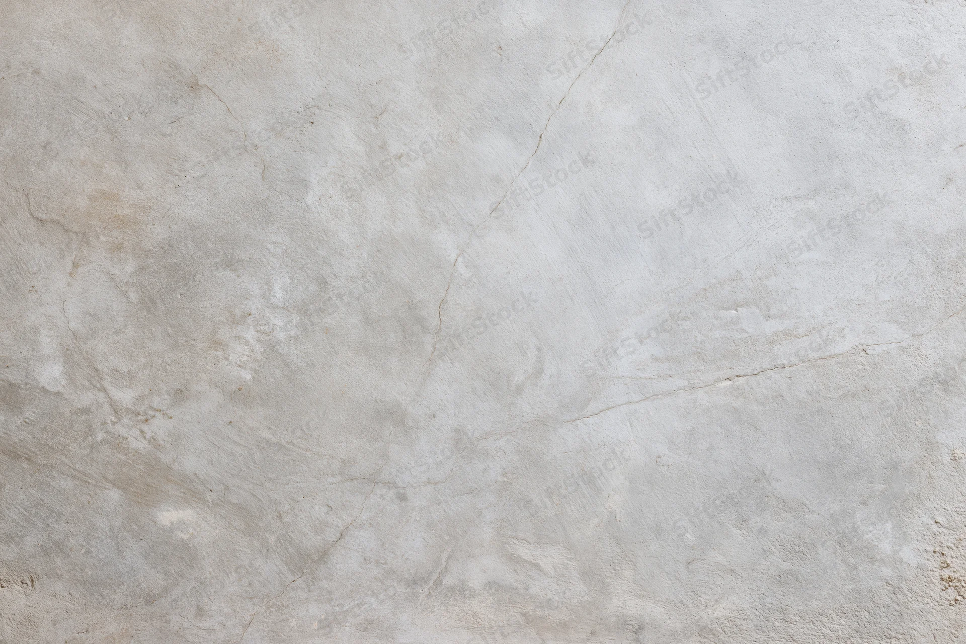 Close-up of a bare concrete wall surface with natural cracks and texture filling the frame
