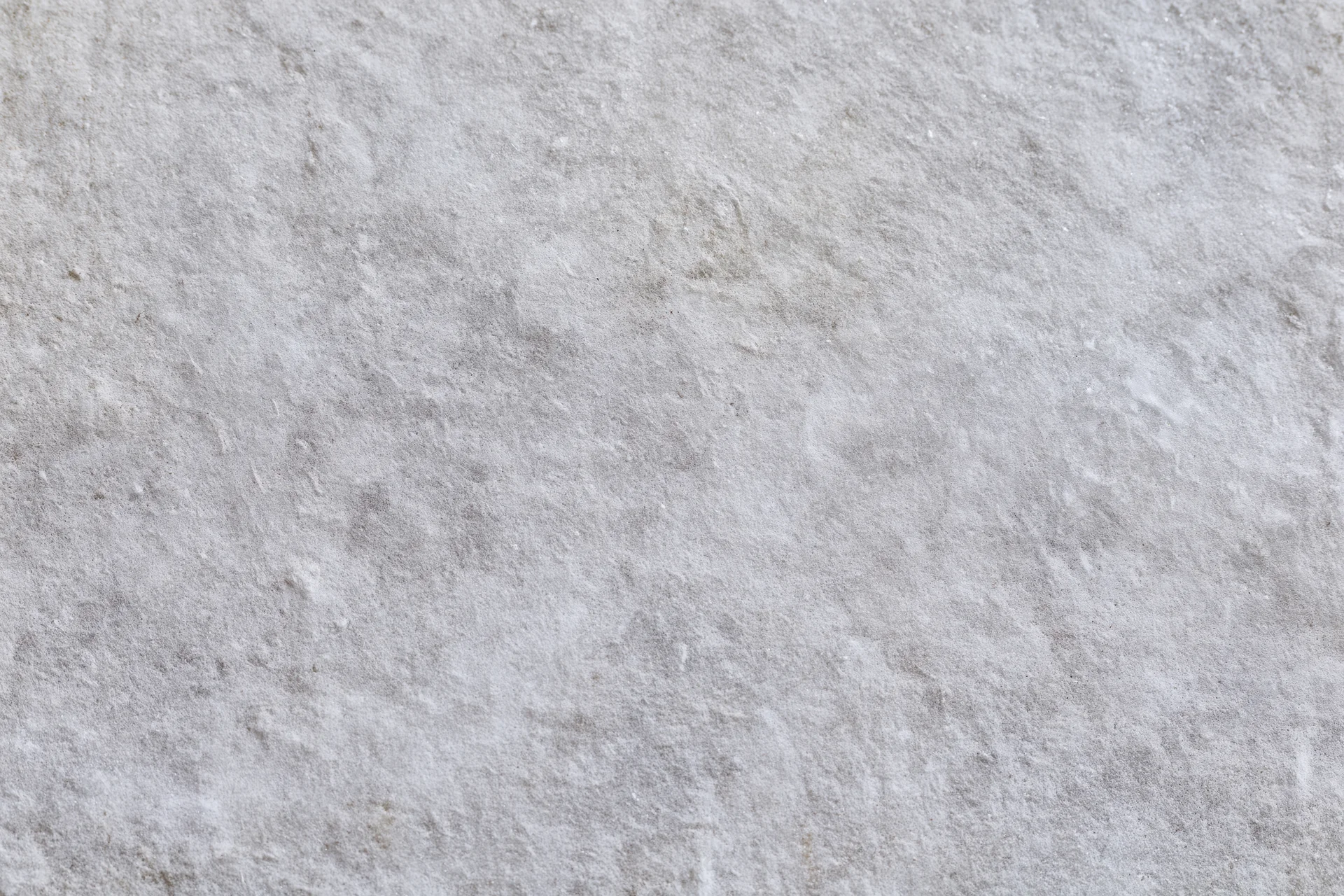 Close-up of a rough gray concrete wall surface filling the frame