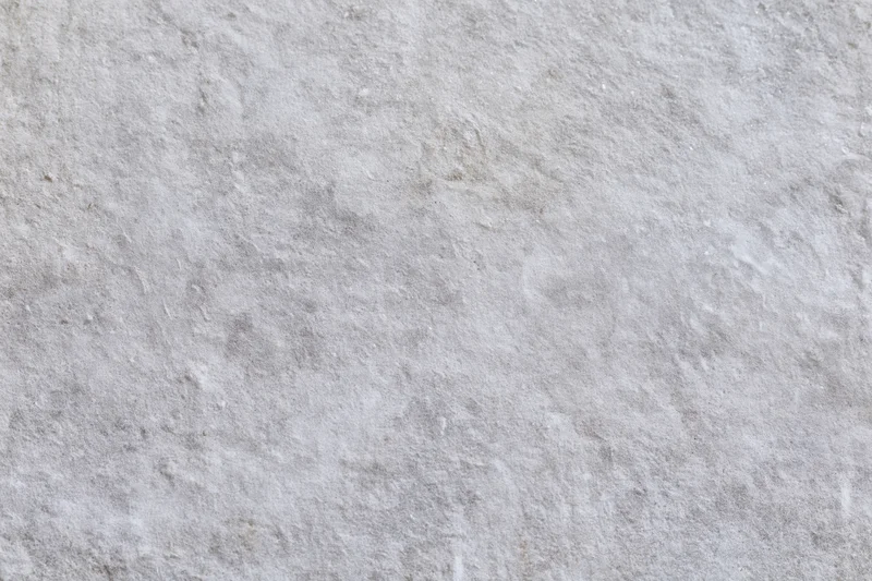 Close-up of a rough gray concrete wall surface filling the frame