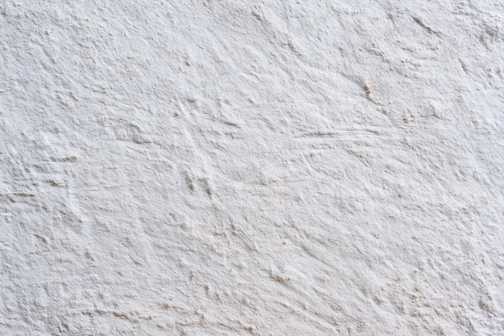 Close-up of a white plastered concrete wall with rough uneven texture