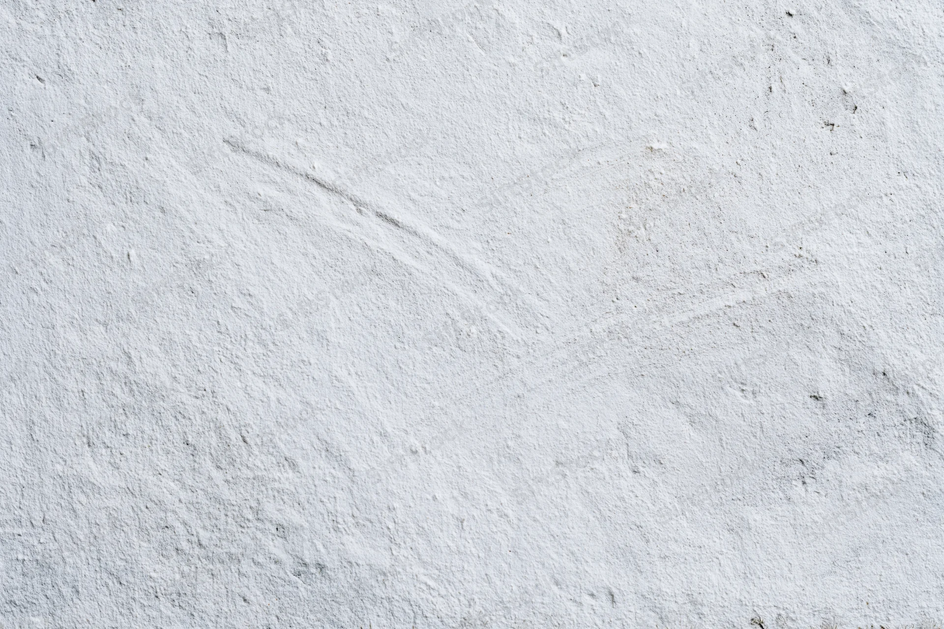 Close-up of a white plastered concrete wall with rough uneven texture